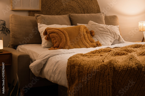 Bed with cozy blanket and s...