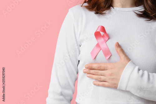 Young woman with pink ribbo...
