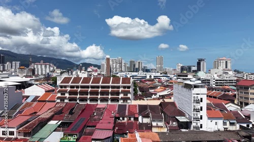 Aerial drone video rising up above rooftops of buildings in old town area of George Town, Penang in Malaysia