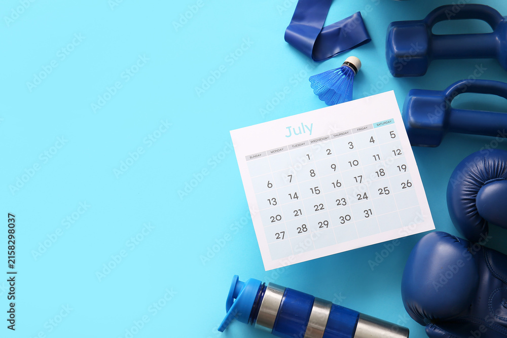 Fototapeta premium Composition with calendar and different sports equipment on color background