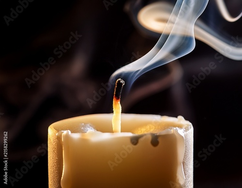 extinguished candle wick with rising smoke and melted wax drips in a sharp focus macro shot for wellness and spiritual branding