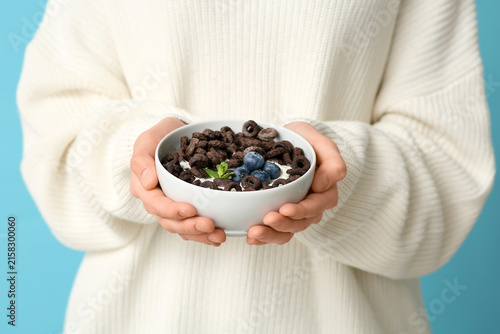 Young woman holding bowl wi...
