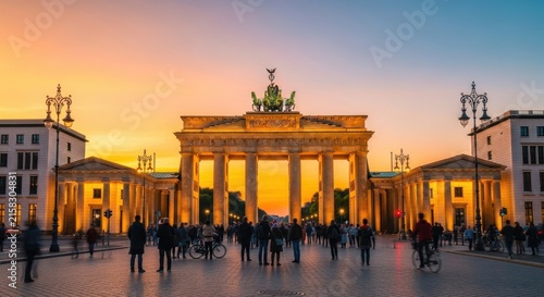 Brandenburg Gate at golden hour with visitors in Berlin.