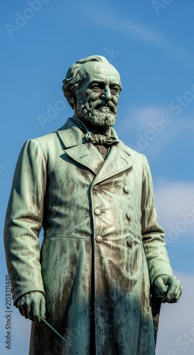 Bronze statue of a historical figure in formal attire.