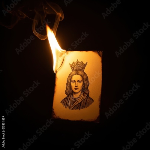 Burning candle with vintage portrait illustration on label.