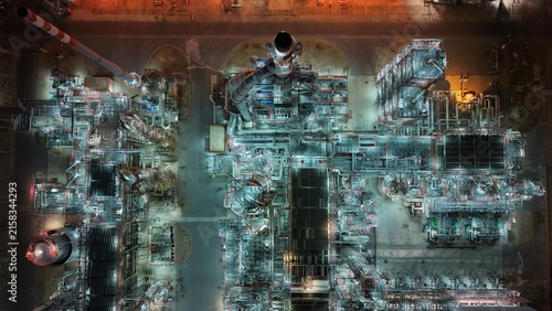 Aerial view of the South industrial zone featuring a complex refinery with illuminated pipes, towers, and chimneys at night in Pancevo, Serbia.