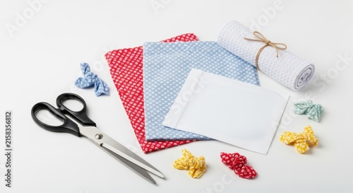 Colorful crafting supplies and tools on white background.