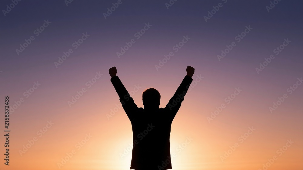 Fototapeta premium Silhouette of a person raising arms in triumph against a vibrant sunset sky with purple and orange hues.