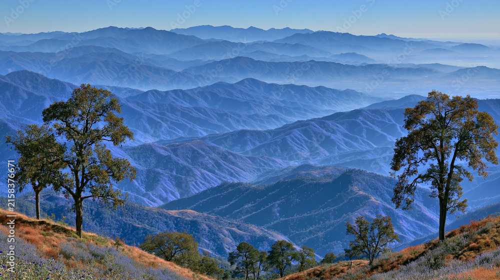 Naklejka premium Breathtaking panoramic view of distant blue mountain ranges fading into morning mist