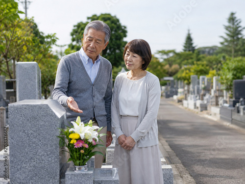 Senior Couple Discussing a Family Grave at a Japanese Cemetery