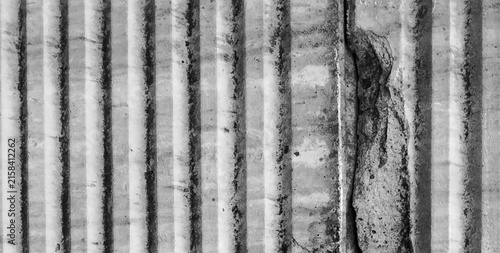 Canvas Print Damaged vertical grooved concrete texture with cracks