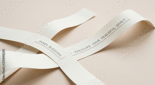 Paper fortune cookie strips with inspirational messages and words of wisdom