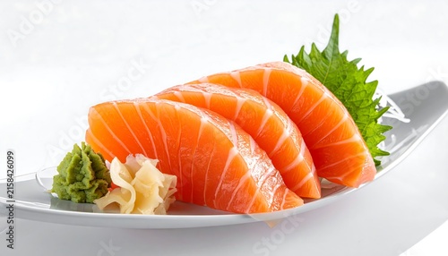 Freshly sliced carrots with parsley garnish on white plate.