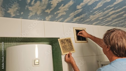 Person is cleaning the ventilation system. This process improves air circulation and removes odors.