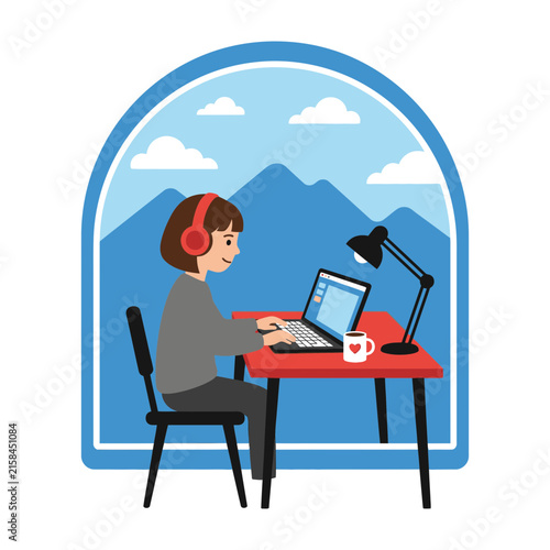 woman wearing headphones working on laptop at desk with mountain view