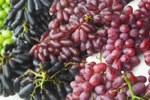 Different kinds of fresh grapes close up