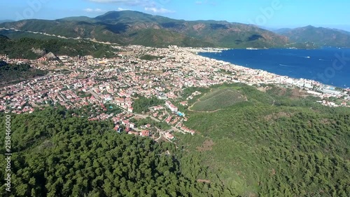 Marmaris Mugla Turkey bay curves beside pine hills, resort harbor and coastal rooftops.