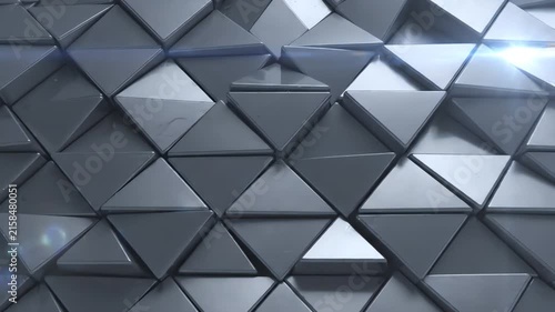 Seamless loop of 3D metallic gray triangles shifting and rotating in a complex geometric pattern with soft shadows and elegant depth