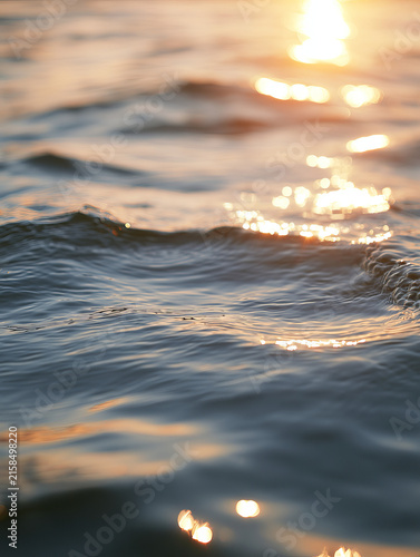 capturing gentle ripples on the surface of water during a golden hour. the su...