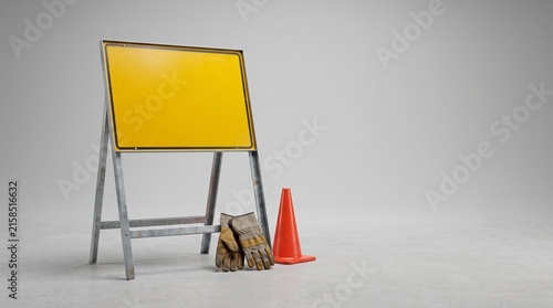 Yellow sign on metal stand with orange cone and debris
