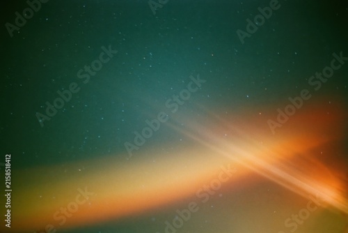 The Aurora Over a Starry Night Sky with Colorful Bands and Glow