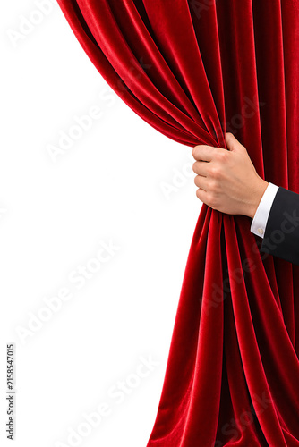 A hand pulling back a luxurious red velvet curtain isolated on transparent background for theatrical reveal