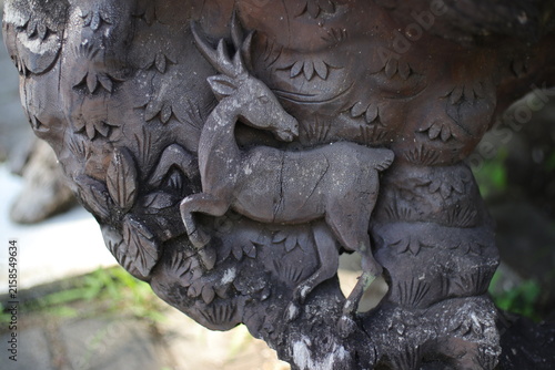 Photography Detailed wooden carving of a majestic deer, showcasing intricate craftsmanship a