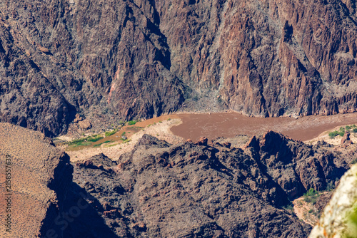 Foto Muddy River Winding Through a Steep Desert Canyon