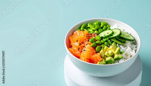 Fresh salmon poke bowl with avocado and edamame on a light blue background