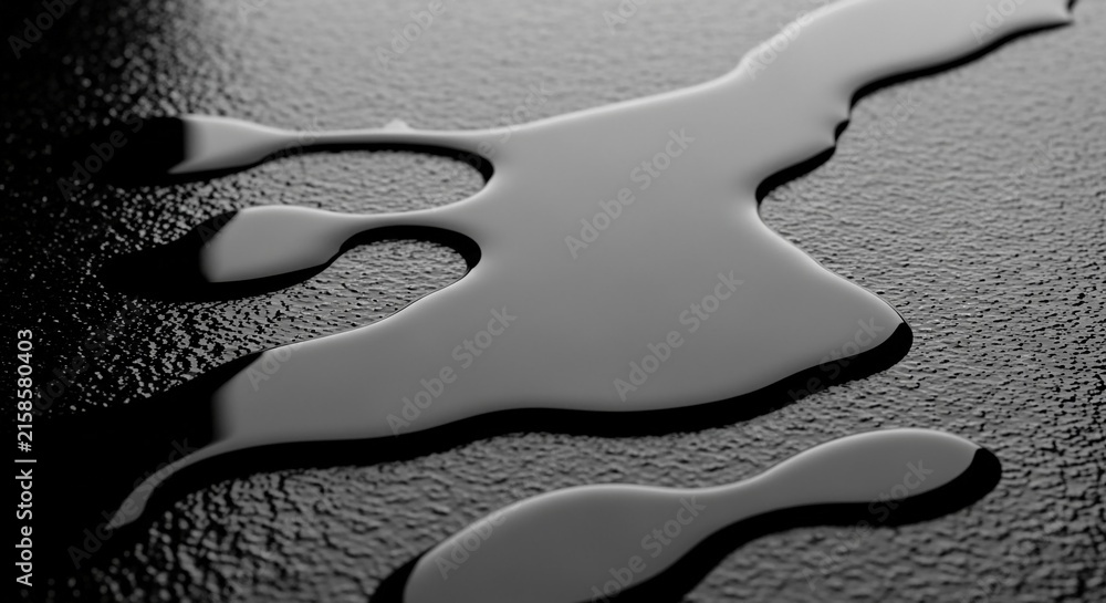 Fototapeta premium Close-up macro of a dark oil spill creating abstract shapes on a textured surface with dramatic lighting