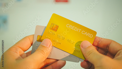 Online payment, hands holding gold and silver credit cards for e-commerce shopping concept.