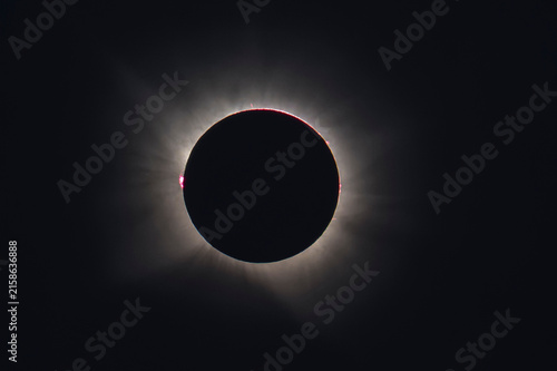 Cuadro en lienzo Telephoto astrophotography of total solar eclipse totality featuring a subtle solar corona and a vibrant pink solar prominence on the limb