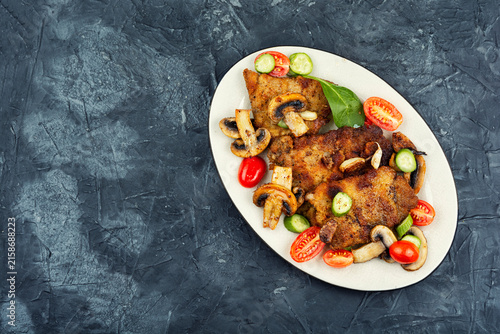 Meat chops with fresh vegetables.