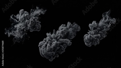 Abstract black and white smoke plumes swirling in slow motion on dark background