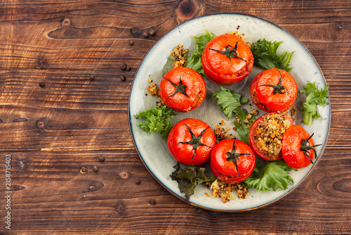 Vegetarian stuffed tomatoes with quinoa and fresh greens