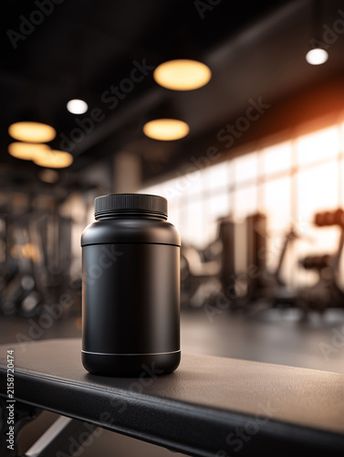 Black supplement plastic protein powder jar bottle on gym interior background, concept of fitness nutrition and training support