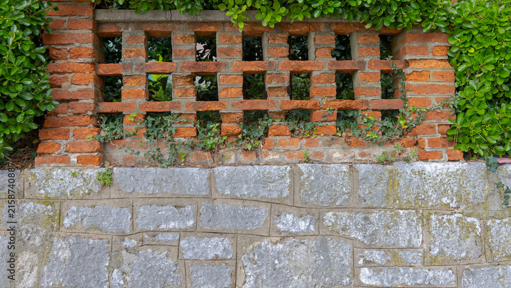Fototapeta premium Orange Brick Fence at Top of Stone Wall at Town Park in Opatija Croatia