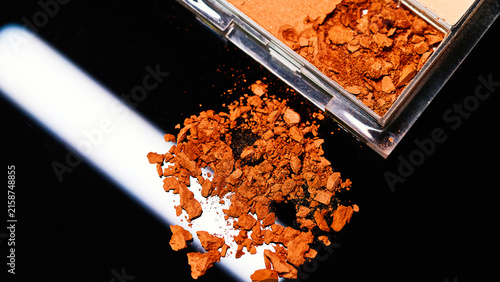 Canvastavla Colorful pigments spill from a compact under the bright lights of a creative mak