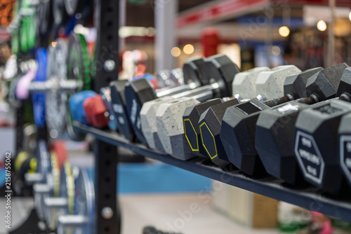 various fitness dumbbells and sports goods displayed on exhibition stand