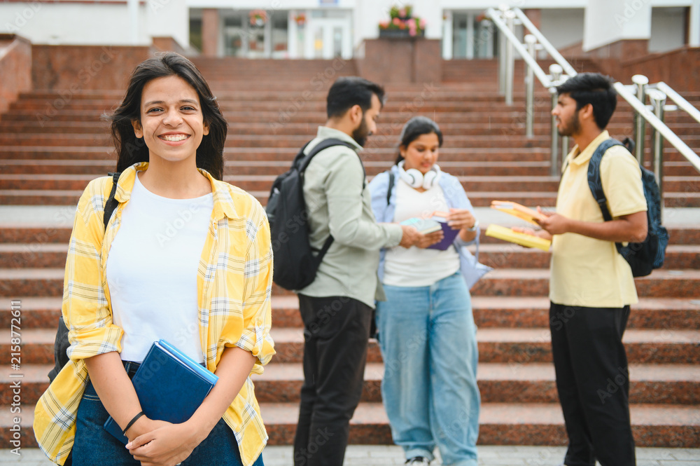 Fototapeta premium Happy indian student smiling on university campus