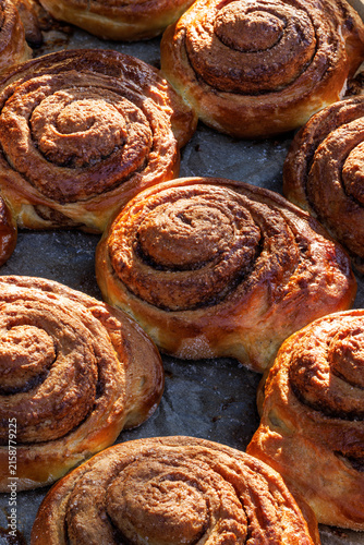 Cinnamon rolls, delicious traditional yeast pastry with addition cinnamon, brown sugar and butter, close-up