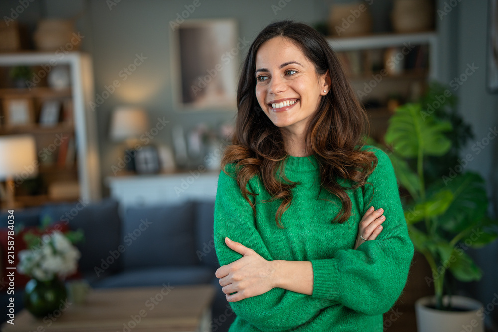 Fototapeta premium Happy woman smiling looking away at home