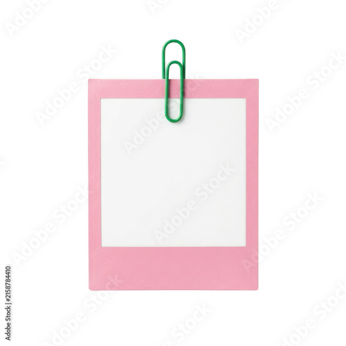 Pink paper note with a green paperclip isolated on white background