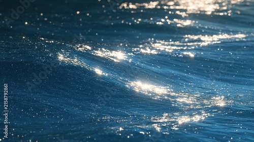 Ocean waves glimmer under bright sunlight creating a sparkling texture.