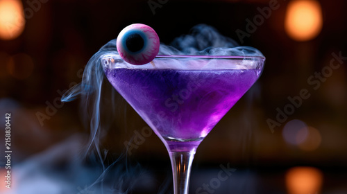 Purple Halloween cocktail with candy eyeball and swirling smoke creates eerie festive atmosphere at night