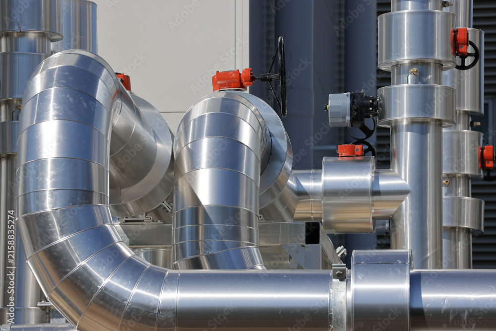 Obraz premium Data centre cooling water pipe bends and valves in insulated mechanical pipework