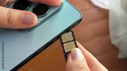 Close up of woman installing SIM card in smartphone, cellular service, mobile communication and internet connection.