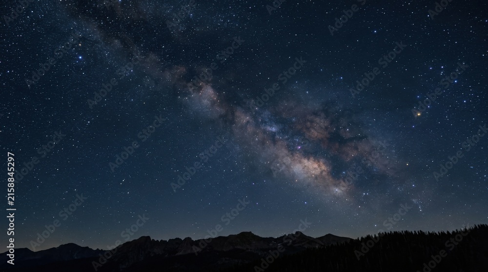 Fototapeta premium Clear Night Sky with Bright Milky Way Galaxy Over Mountain Silhouette
