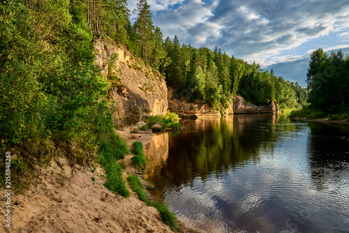 фотографія Scenic River Landscape with Forested Cliffs and Sandy Shore