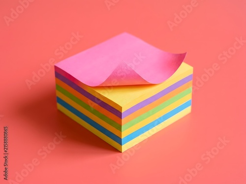Stack of colorful sticky notes on a pink background, ready for reminders